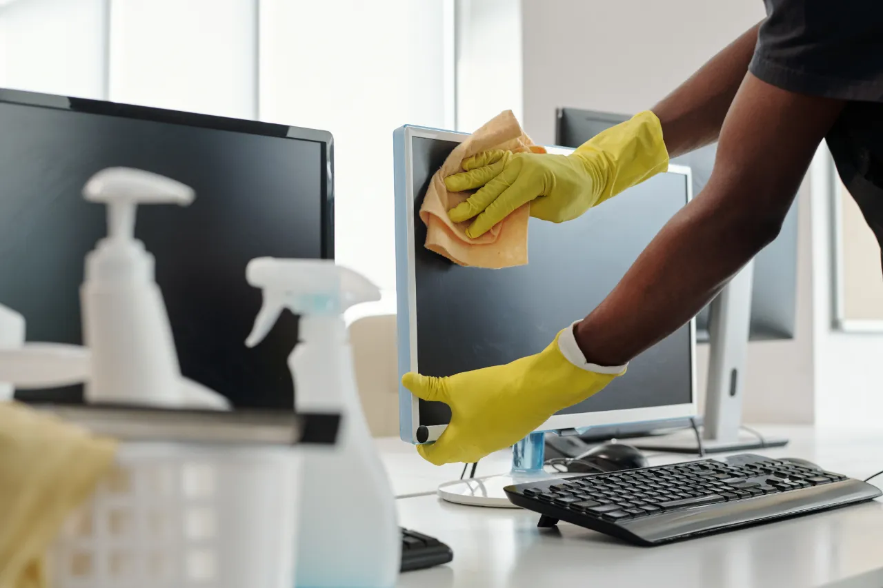 Wiping down office computer monitor