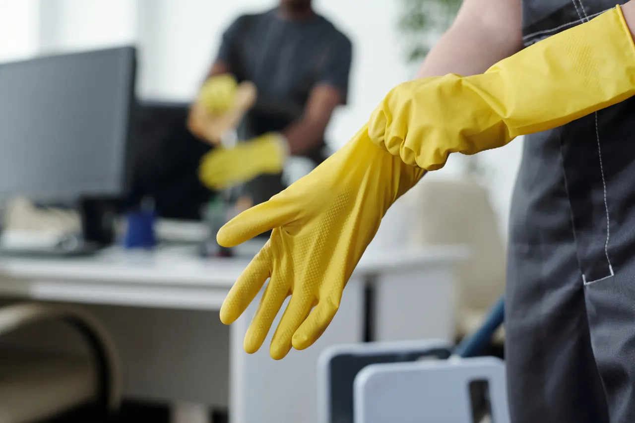 Office cleaning with protective gloves